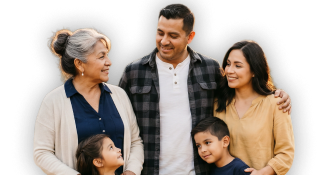 A happy multi‑generational family stands close together, smiling and embracing each other outdoors or against a plain background.