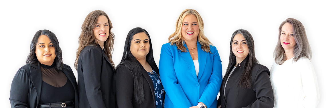 Professional team posing for a group photo: six diverse women in business attire, standing together and smiling.